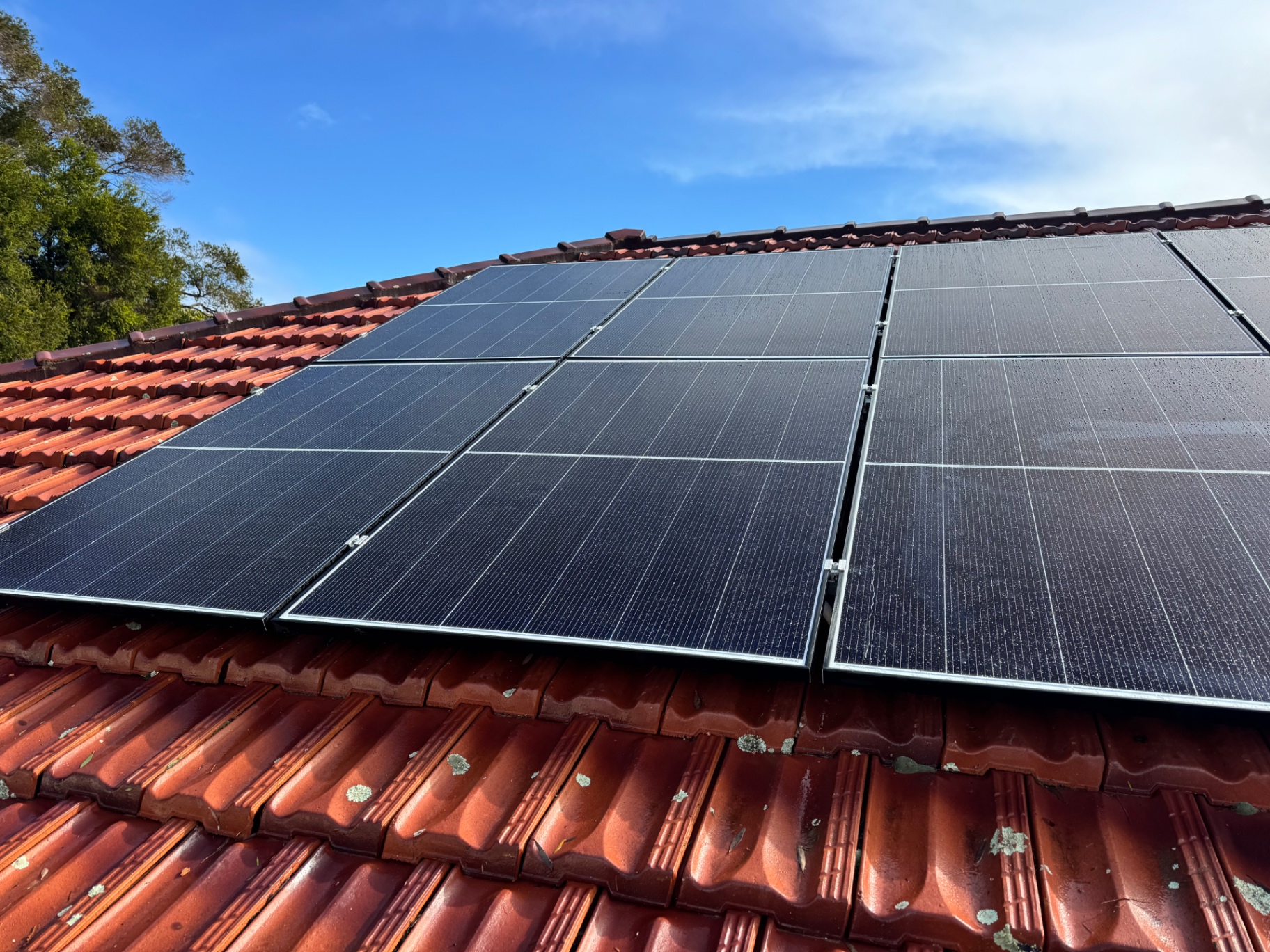 Solar panels beside a solar hot water system on a Beechboro tile roof