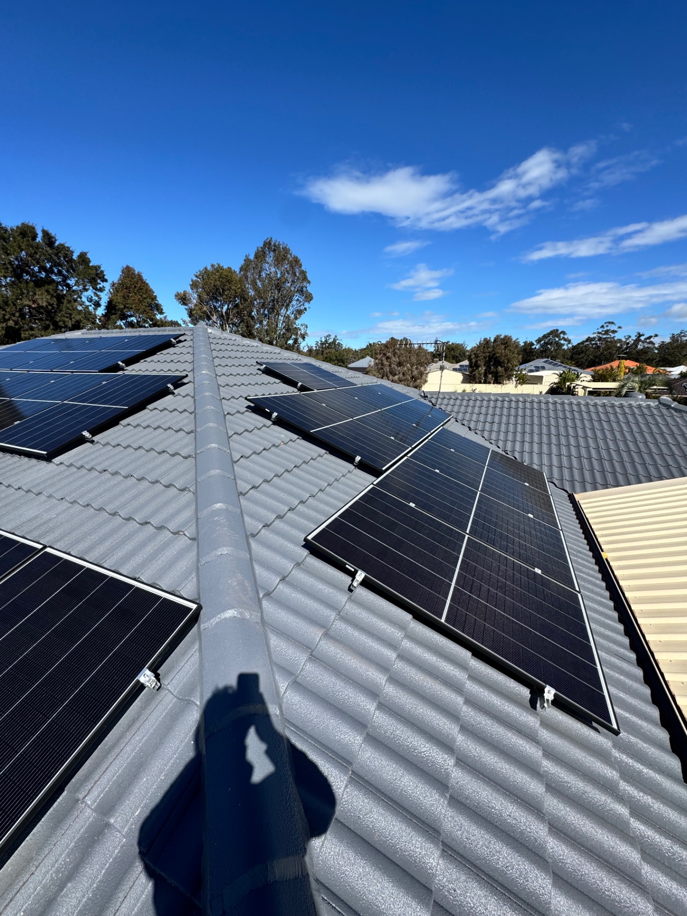 Solar panels split across the roof planes of a Pinjarra home