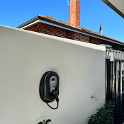 Black wall-mount charger — rendered exterior