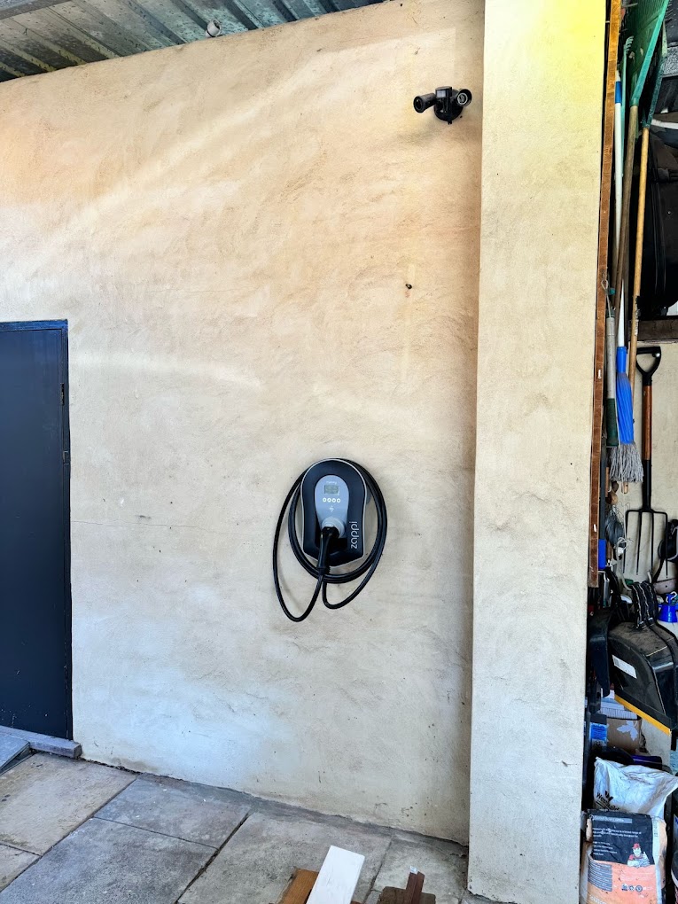 Zappi on a rendered carport wall