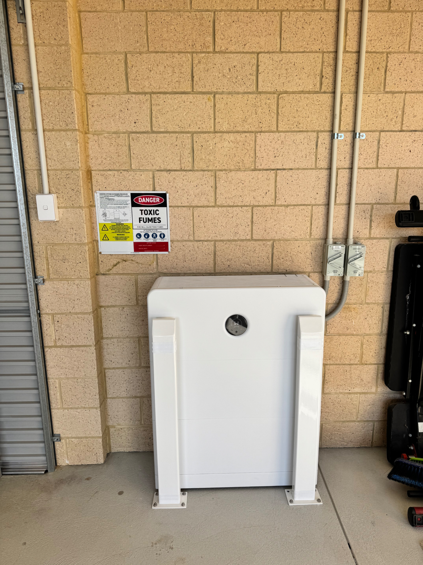 16kWh GoodWe ESA all-in-one battery installed on a brick wall in a Coogee garage
