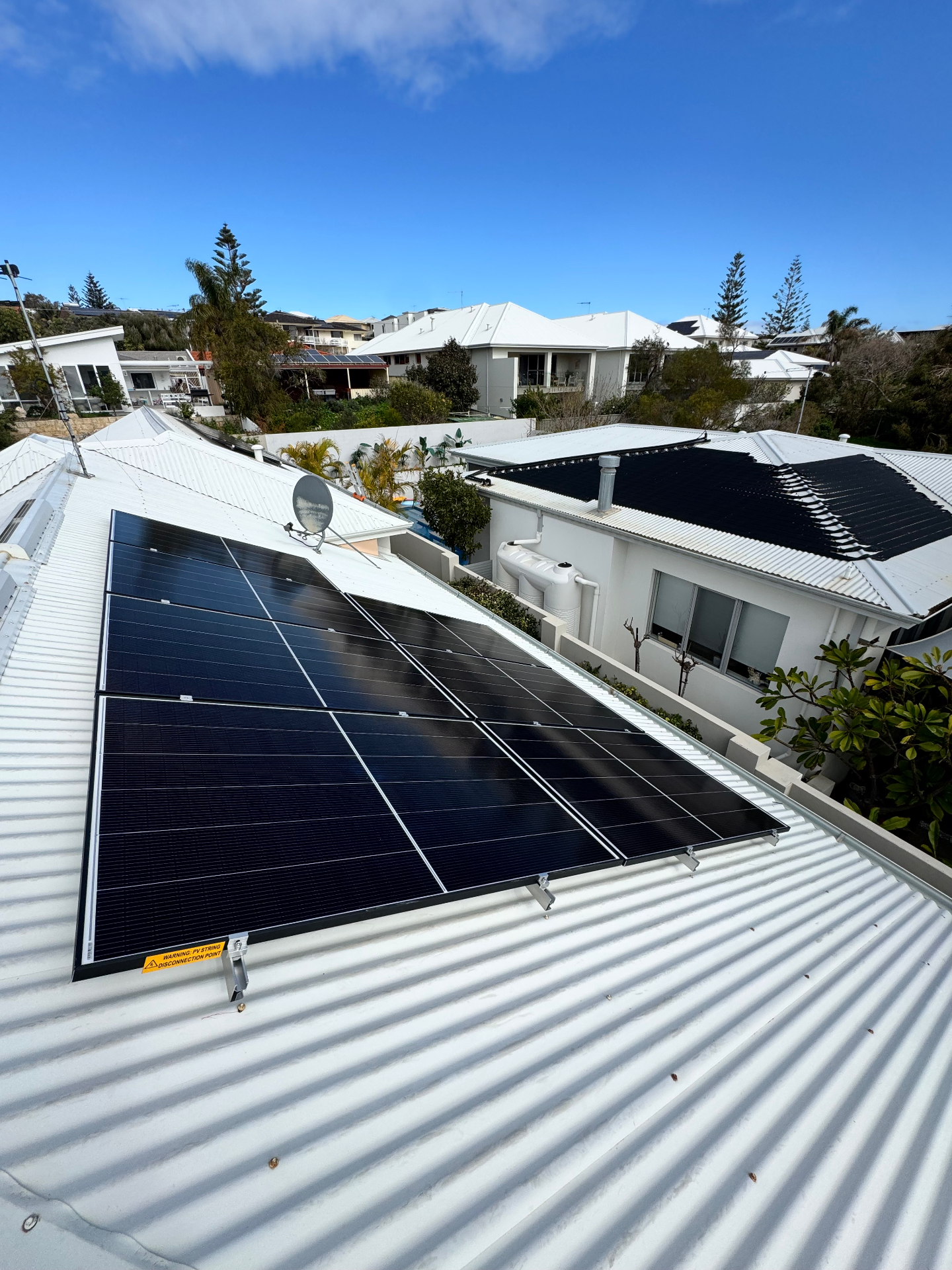 Second Jinko solar array on a white corrugated roof in North Beach