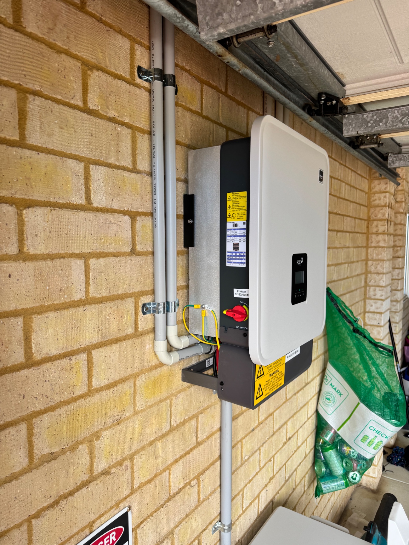 Side view of the Fox ESS KH10 inverter with labelled conduit