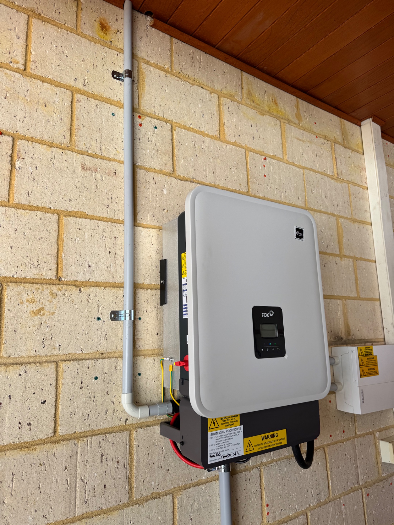 Fox ESS hybrid inverter mounted on a Beechboro garage wall