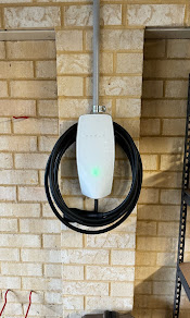 Tesla-style wall connector — brick facade