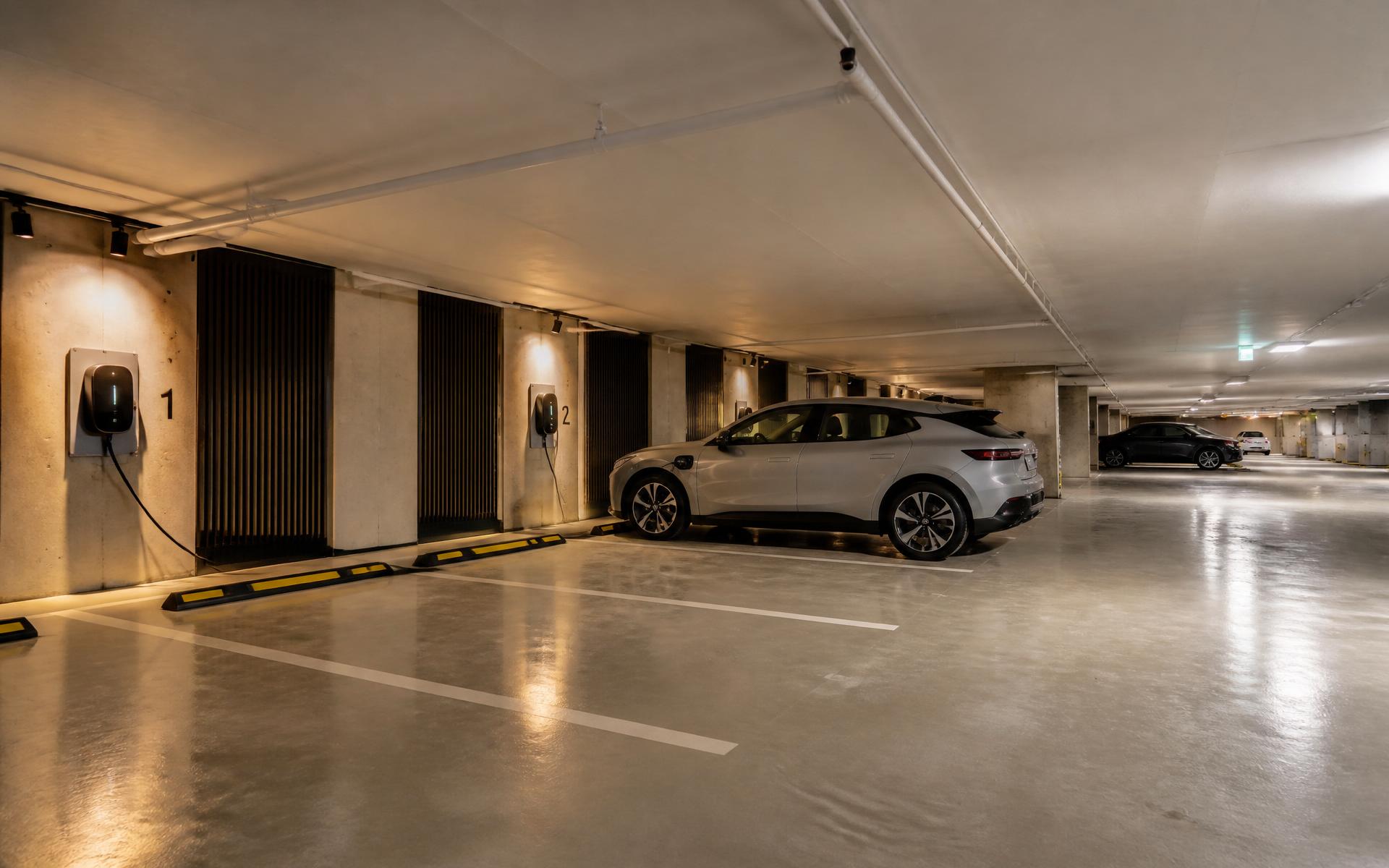 Modern Perth apartment building basement carpark with EV chargers on numbered bays