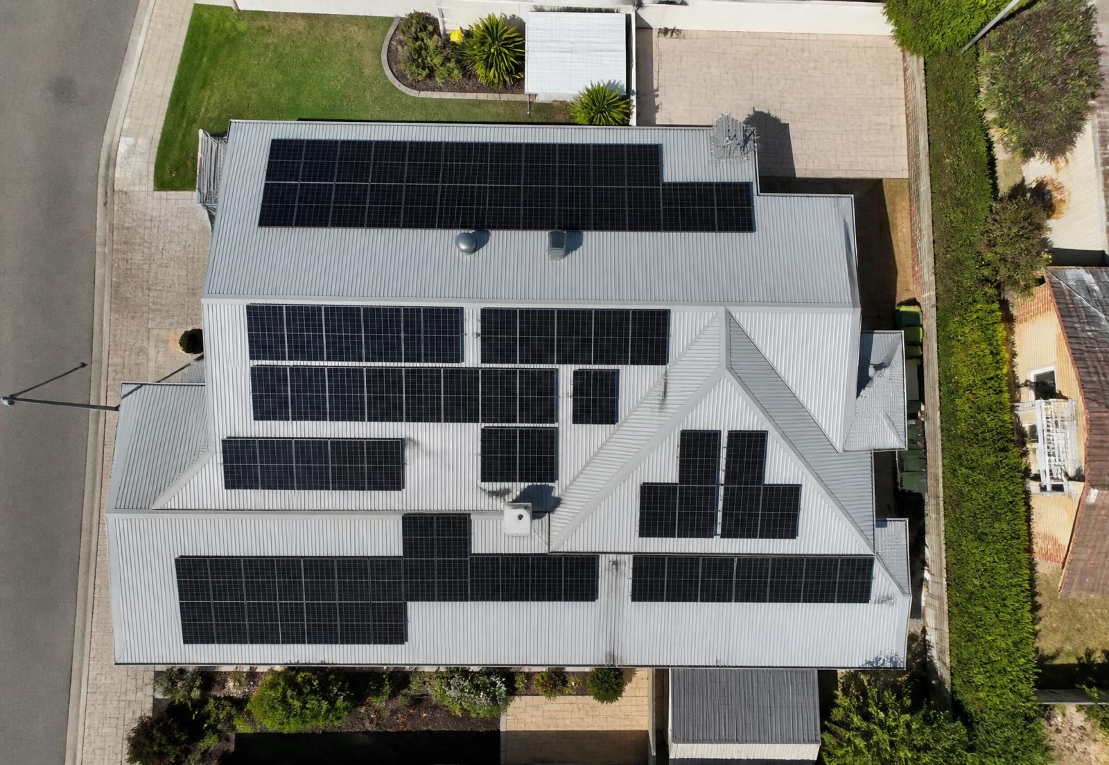 Aerial view of a Perth home fully covered in solar panels